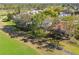 Aerial view of homes nestled on landscaped grounds with golf course views and a sidewalk at 11231 Sun Tree Rd, Hudson, FL 34667