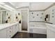 Updated bathroom with walk-in shower, bathtub, vanity with large mirror, and decorative butterfly decals at 11231 Sun Tree Rd, Hudson, FL 34667