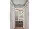 Hallway view into bathroom with shower and soaking tub with decorative tile accents and marble flooring at 11231 Sun Tree Rd, Hudson, FL 34667