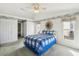 Comfortable bedroom has vaulted ceiling, a ceiling fan and access to ensuite bathroom and closet space at 11231 Sun Tree Rd, Hudson, FL 34667
