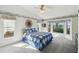 Light-filled bedroom boasts a vaulted ceiling, a ceiling fan, and picturesque views from multiple windows at 11231 Sun Tree Rd, Hudson, FL 34667