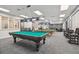 Billiard room featuring several pool tables and comfortable seating at 11231 Sun Tree Rd, Hudson, FL 34667