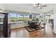 Bright bonus room with wood floors, a ceiling fan, and a wall of windows offering a scenic view at 11231 Sun Tree Rd, Hudson, FL 34667