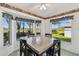 Sunlit breakfast nook offers golf course views from the bay window area with marble tabletop and seating for four at 11231 Sun Tree Rd, Hudson, FL 34667