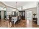 Dining room with chandelier lighting, hardwood floors, and an adjacent living area at 11231 Sun Tree Rd, Hudson, FL 34667