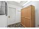 Hallway featuring a door, a storage cabinet, and a decorative rug at 11231 Sun Tree Rd, Hudson, FL 34667