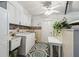 Functional laundry room with washer, dryer, utility sink, cabinets and ceiling fan at 11231 Sun Tree Rd, Hudson, FL 34667