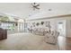 Spacious living room features a vaulted ceiling, neutral carpet, and an abundance of natural light at 11231 Sun Tree Rd, Hudson, FL 34667