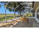 Covered screened patio area with a dining table set at 11231 Sun Tree Rd, Hudson, FL 34667