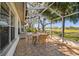 Inviting screened patio with a dining set and views of the lush surroundings at 11231 Sun Tree Rd, Hudson, FL 34667
