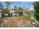 A spacious backyard featuring a shed, well system, and a screened enclosure attached to the house at 11298 Furley Ave, Weeki Wachee, FL 34613