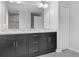 Bathroom featuring a double sink vanity with granite countertop and a large mirror at 11388 Paramount Ave, Weeki Wachee, FL 34614