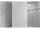 Bathroom tiled walk-in shower with mosaic accents, adjacent to doorway and white-painted wall at 11388 Paramount Ave, Weeki Wachee, FL 34614