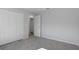 Bedroom with gray carpet, white walls and closet with double doors at 11388 Paramount Ave, Weeki Wachee, FL 34614