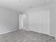 Spacious bedroom offering plush gray carpeting, light gray walls, and a convenient closet for storage at 11388 Paramount Ave, Weeki Wachee, FL 34614