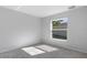 Bedroom with gray carpet and light-gray walls with single window and white trim at 11388 Paramount Ave, Weeki Wachee, FL 34614