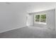 Bedroom featuring neutral carpet, white walls, a window, and a closet at 11388 Paramount Ave, Weeki Wachee, FL 34614