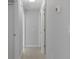 Hallway with multiple closed doors and light gray walls at 11388 Paramount Ave, Weeki Wachee, FL 34614