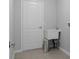 Utility room showcasing ceramic tile flooring, gray walls, a utility sink, and access to the garage at 11388 Paramount Ave, Weeki Wachee, FL 34614