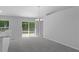 Bright living room with a modern chandelier, large sliding doors, and seamless access to outdoor living spaces at 11388 Paramount Ave, Weeki Wachee, FL 34614