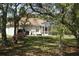 Spacious backyard with mature trees, a covered lanai, and plenty of room for outdoor activities at 11480 Emerald Ridge Ct, Spring Hill, FL 34609