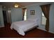 Light and airy bedroom featuring a comfortable bed, hardwood floors, a ceiling fan, and views through the windows at 11480 Emerald Ridge Ct, Spring Hill, FL 34609