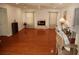 The living room has hardwood floors, a fireplace, and is decorated with neutral-colored furniture and fixtures at 11480 Emerald Ridge Ct, Spring Hill, FL 34609