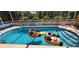 Inviting in-ground pool inside screened in lanai, perfect for fun and relaxation under the sun at 11480 Emerald Ridge Ct, Spring Hill, FL 34609