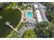 An aerial view of the community pool, with access to a lake with a fishing pier at 11526 Forest Run Ct, Port Richey, FL 34668