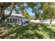 Spacious backyard with patio, a grill, and a lush lawn perfect for outdoor activities and relaxation at 11526 Forest Run Ct, Port Richey, FL 34668