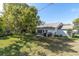 This home includes a well-manicured backyard with a patio and lush lawn, perfect for outdoor enjoyment at 11526 Forest Run Ct, Port Richey, FL 34668