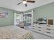 Serene bedroom featuring a ceiling fan, sliding glass doors to the lanai, and neutral decor at 11526 Forest Run Ct, Port Richey, FL 34668