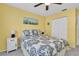 Bright bedroom featuring yellow walls, a ceiling fan, and a comfortable bed with matching nightstands at 11526 Forest Run Ct, Port Richey, FL 34668
