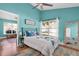Stylish bedroom with blue walls, a large window, and wood-look floors, plus 'sweet dreams' art at 11526 Forest Run Ct, Port Richey, FL 34668