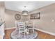Cozy dining room featuring a circular table with seating for four and a modern chandelier at 11526 Forest Run Ct, Port Richey, FL 34668
