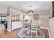 Bright dining area featuring a unique chandelier and coastal-themed decor at 11526 Forest Run Ct, Port Richey, FL 34668
