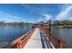 Scenic view of a dock extending into a serene lake, perfect for leisurely strolls and enjoying waterfront views at 11526 Forest Run Ct, Port Richey, FL 34668