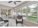 Charming Florida room with tile floors, wicker furniture, and sliding glass doors to the garden at 11526 Forest Run Ct, Port Richey, FL 34668