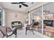 Relaxing Florida room with wicker chairs and sliding glass door to the living room and backyard at 11526 Forest Run Ct, Port Richey, FL 34668