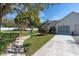 Charming home with a well-maintained front yard, featuring lush landscaping and a welcoming walkway to the front door at 11526 Forest Run Ct, Port Richey, FL 34668