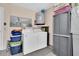 A practical laundry area with washer, dryer, water heater, and ample storage space in a cozy utility room at 11526 Forest Run Ct, Port Richey, FL 34668