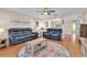 Comfortable living room with ceiling fan, hardwood floors, and contemporary furniture at 11526 Forest Run Ct, Port Richey, FL 34668