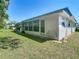 Back exterior of home with a patio door that opens to a lovely green backyard at 11917 Bayonet Ln # 11917, New Port Richey, FL 34654