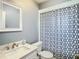 Bathroom featuring a sink and vanity with mirror, toilet, and shower with patterned curtain at 11917 Bayonet Ln # 11917, New Port Richey, FL 34654