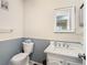 Cozy bathroom featuring a toilet, vanity with sink, and framed mirror at 11917 Bayonet Ln # 11917, New Port Richey, FL 34654