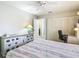 Serene bedroom featuring a dresser, closet, desk, and a queen bed at 11917 Bayonet Ln # 11917, New Port Richey, FL 34654