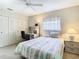 Inviting bedroom features a ceiling fan, closet, desk, and a queen bed at 11917 Bayonet Ln # 11917, New Port Richey, FL 34654