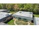Aerial view of a charming home with a well-maintained lawn and lush greenery surrounding the property at 11917 Bayonet Ln # 11917, New Port Richey, FL 34654