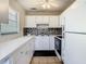 Bright kitchen featuring white cabinets, tiled backsplash, modern appliances, and tile flooring at 11917 Bayonet Ln # 11917, New Port Richey, FL 34654