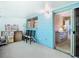 Enclosed lanai featuring blue wall, seating and sliding glass door to the bedroom at 11917 Bayonet Ln # 11917, New Port Richey, FL 34654